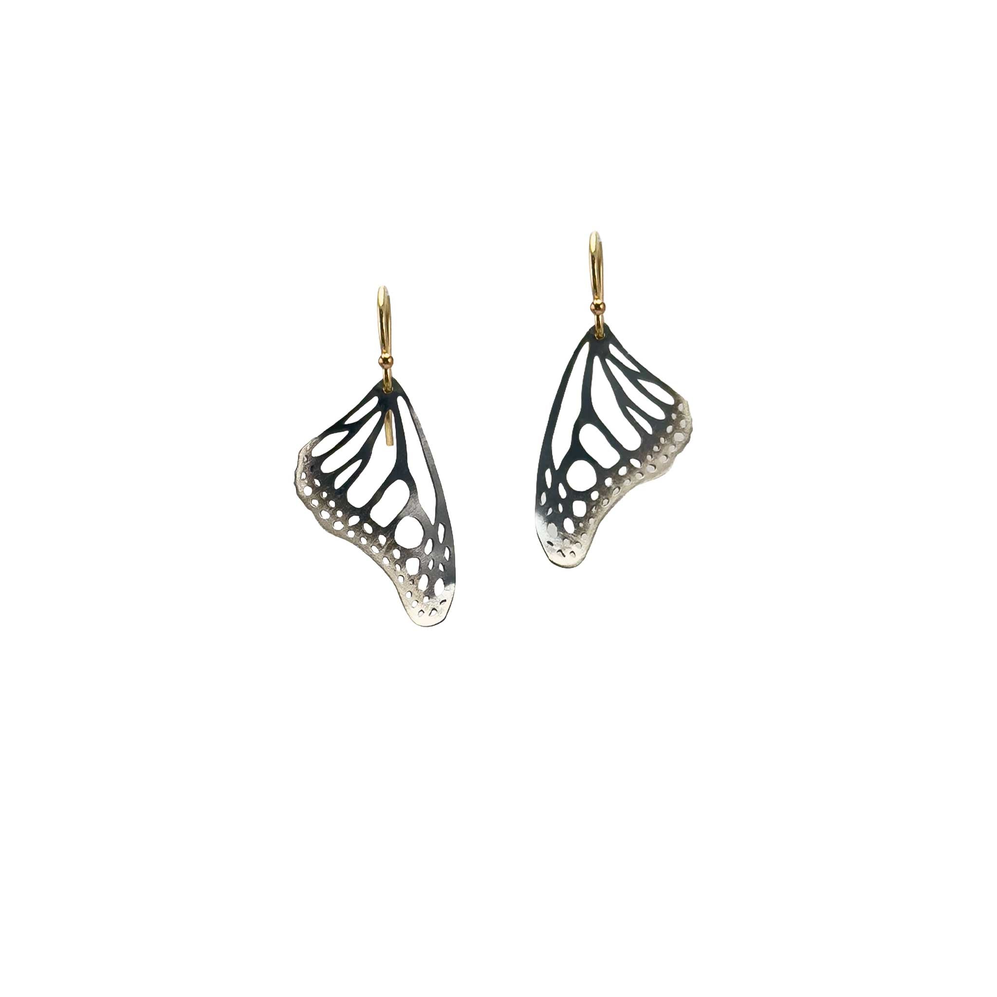 Handmade small Monarch butterfly drop earrings in oxidized silver with 14k gold ear wires over a white background
