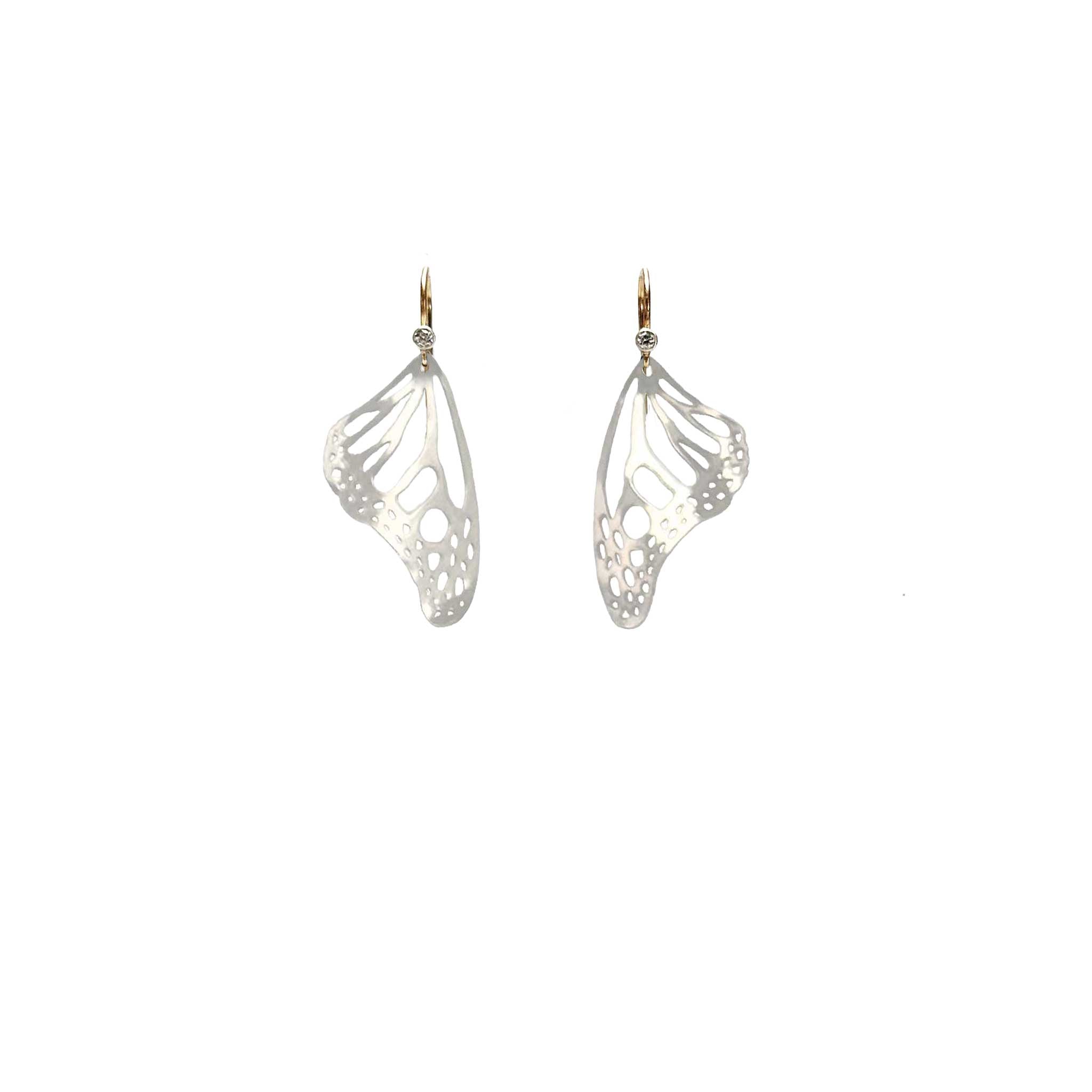 Handmade small Monarch butterfly dangle earrings in sterling silver with 14k gold and diamond ear wires over a white background | Camille Torres Designs