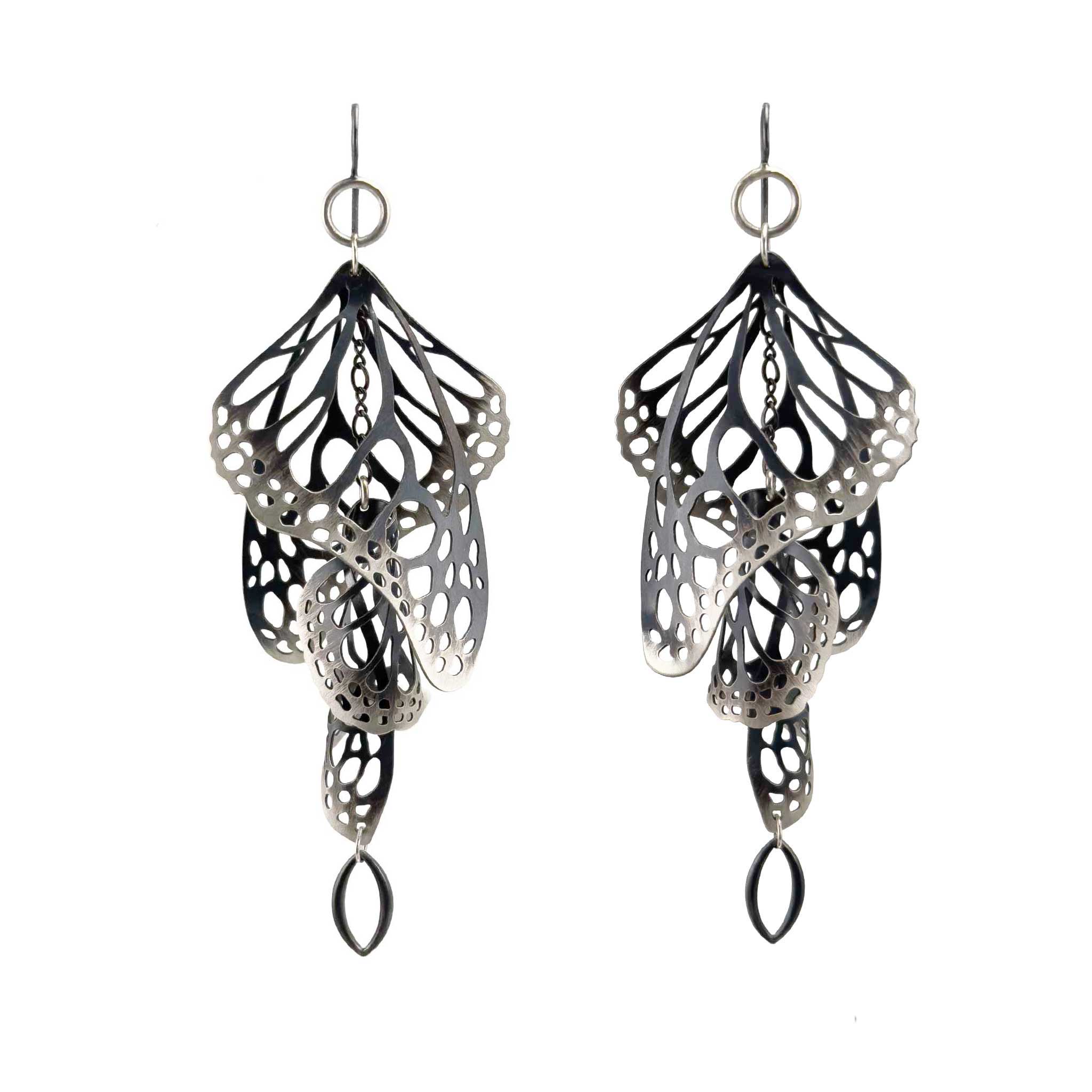Pair of black and silver Overwinter monarch chandelier duster earrings on a white background.