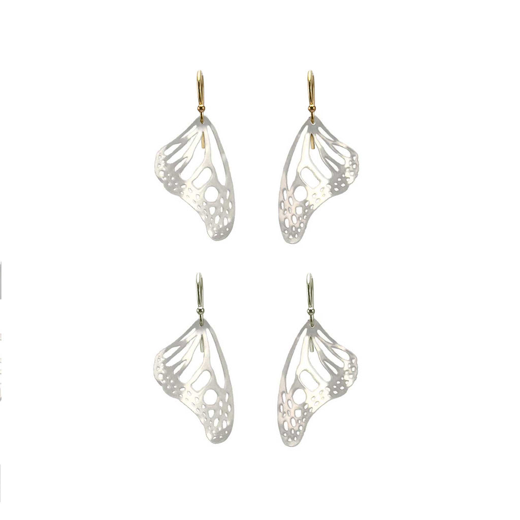 Two pairs of silver Monarch butterfly-wing shaped earrings with gold and silver ear wires on a white background