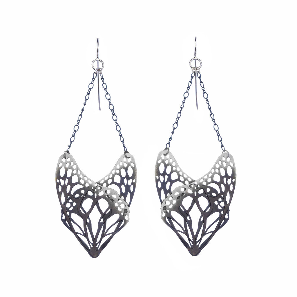 Pair of Slumber oxidized silver monarch wing earrings on a white background