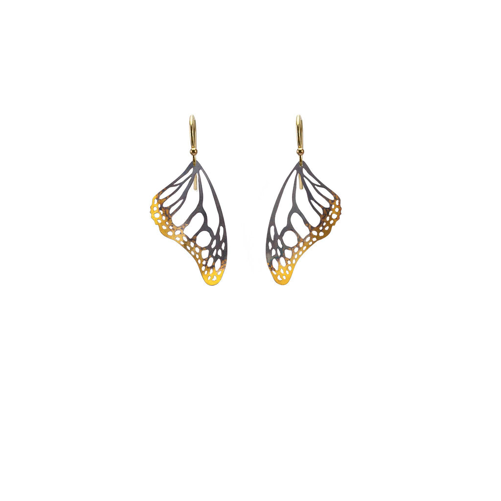 Butterfly wing mixed metal black and gold dangle earrings with 14k ear wires on a white background