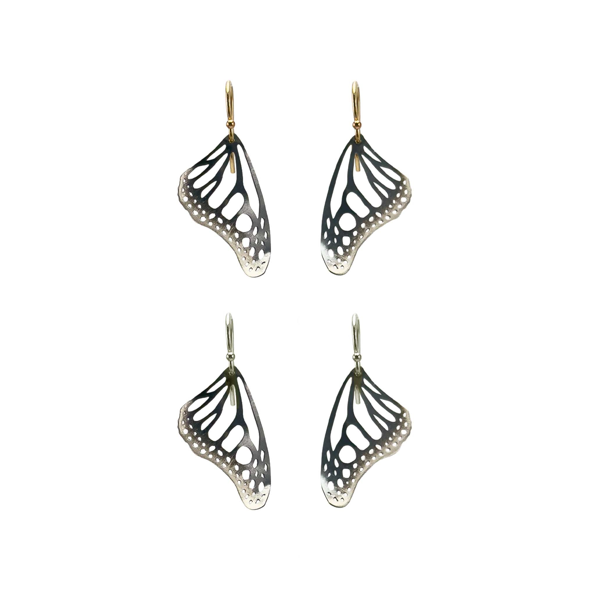 Two pair of Monarch butterfly-wing shaped earrings with silver and gold ear wires on a white background