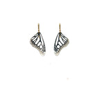 Black Monarch butterfly wing earrings on with gold ear wires on a white background