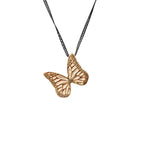 Whisper butterfly charm pendant necklace  with an oxidized silver chain on a white background