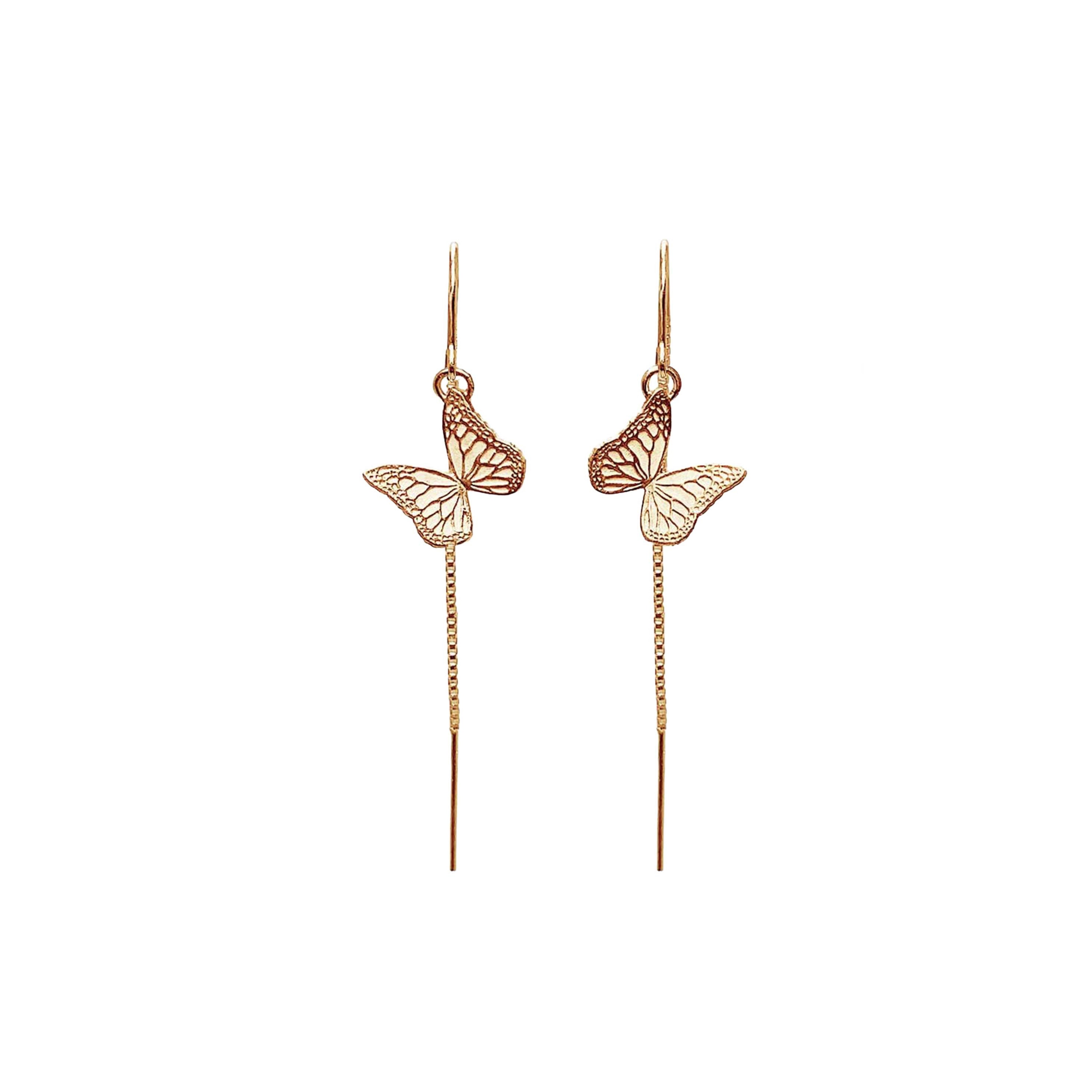 Gold monarch butterfly threader earrings on a white background