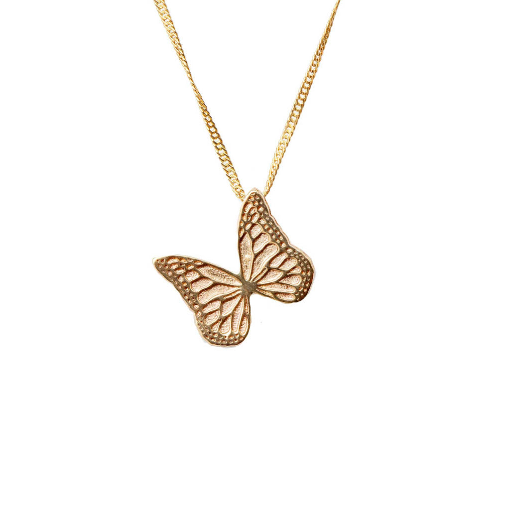Whisper gold butterfly pendant necklace on a white background