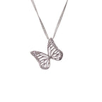 Silver butterfly charm on a chain against a white background | Camille Torres Designs