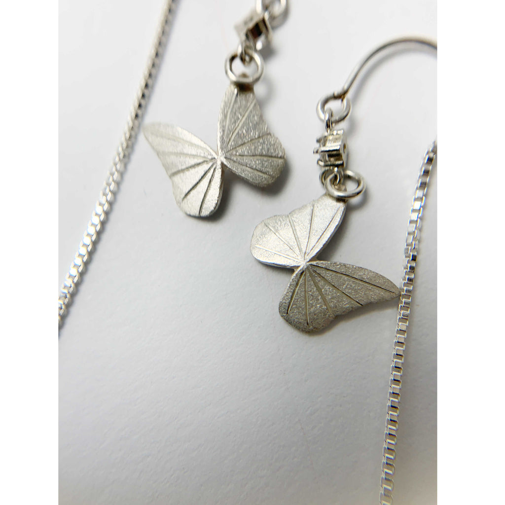 Silver Whisper butterfly  threader earrings engraved back view on a light gray background